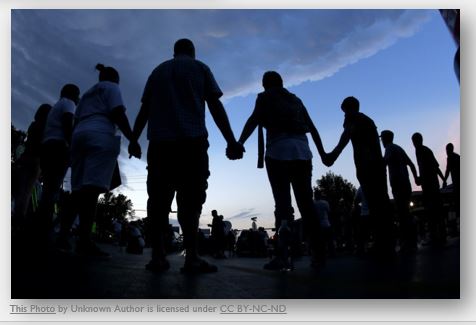 Photo of a silhouette of people praying